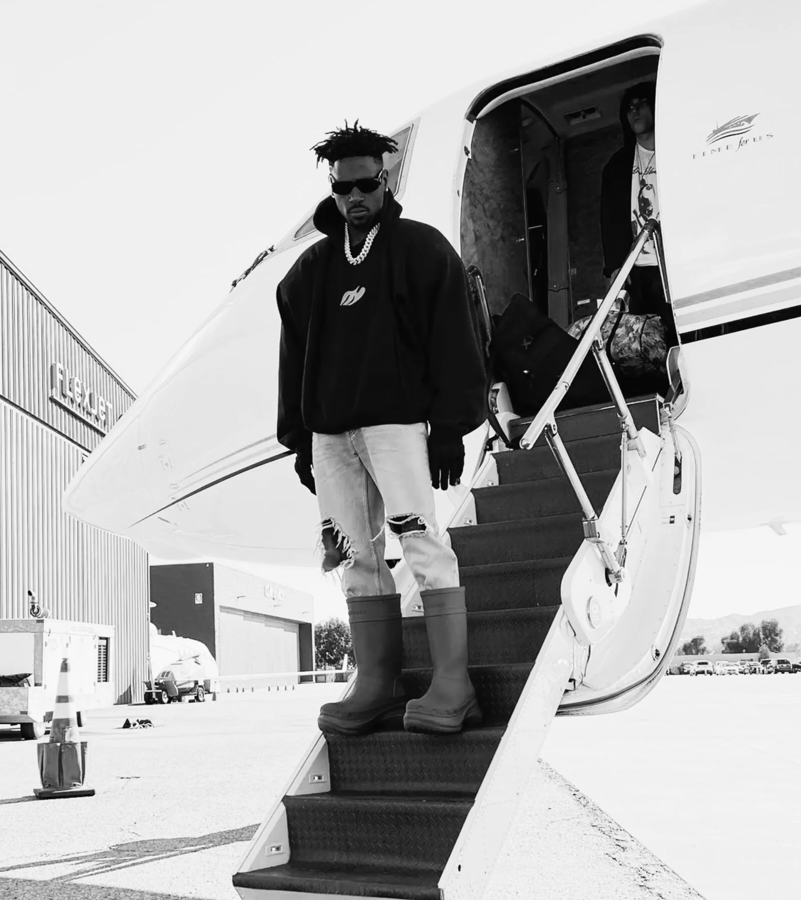 ALTHEAMEN client boarding a private aircraft, black and white