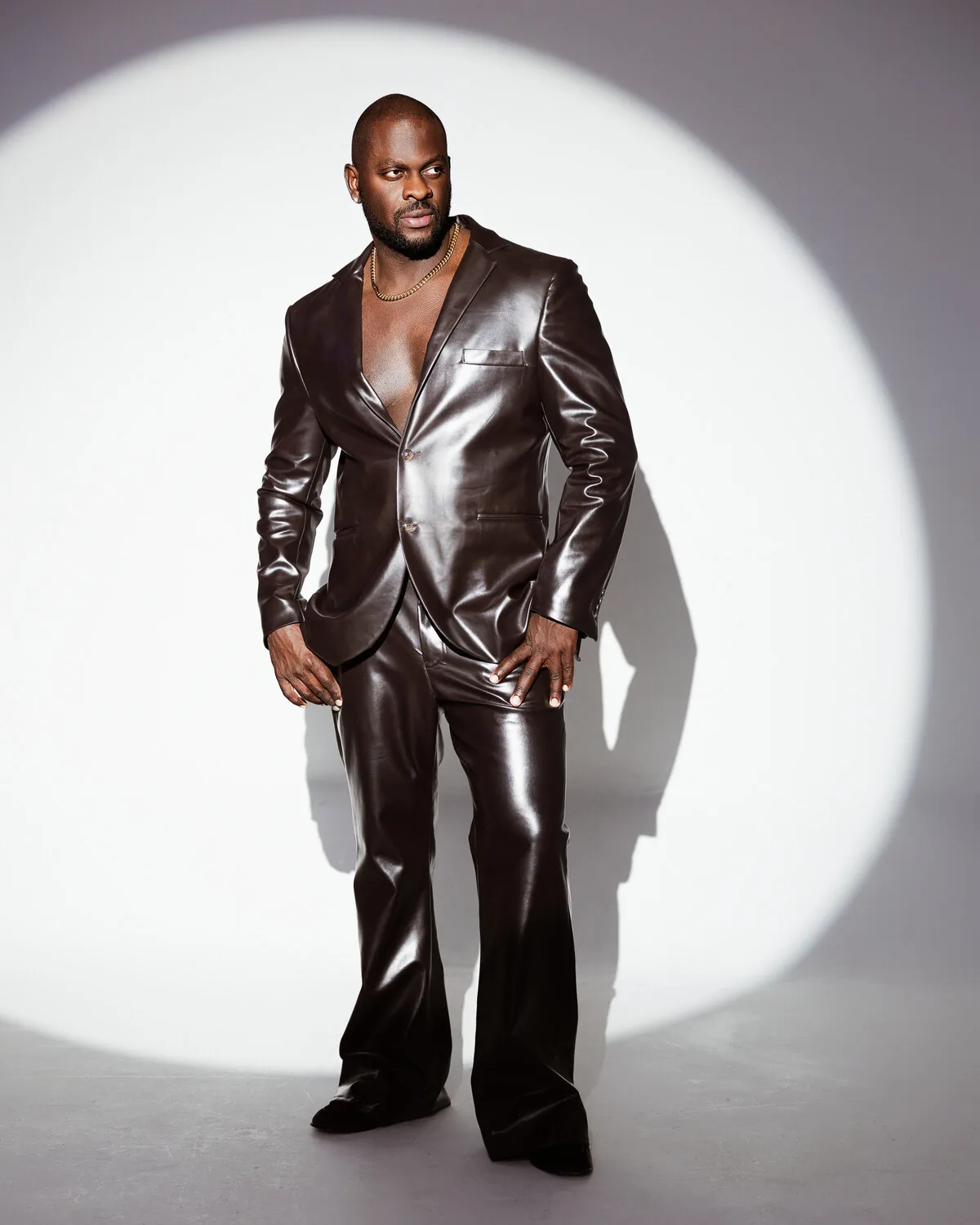 Chocolate patent leather suit worn open